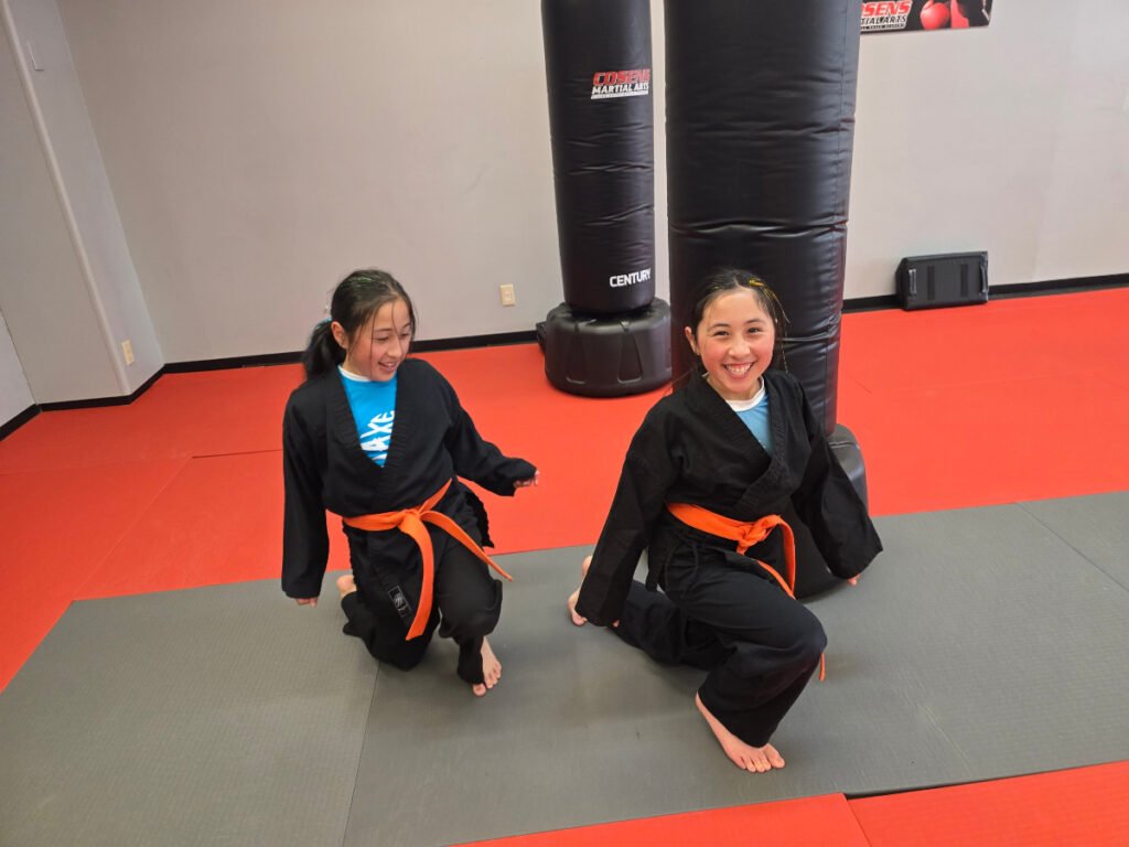 Child in Bad Axe doing breathing exercise in martial arts class